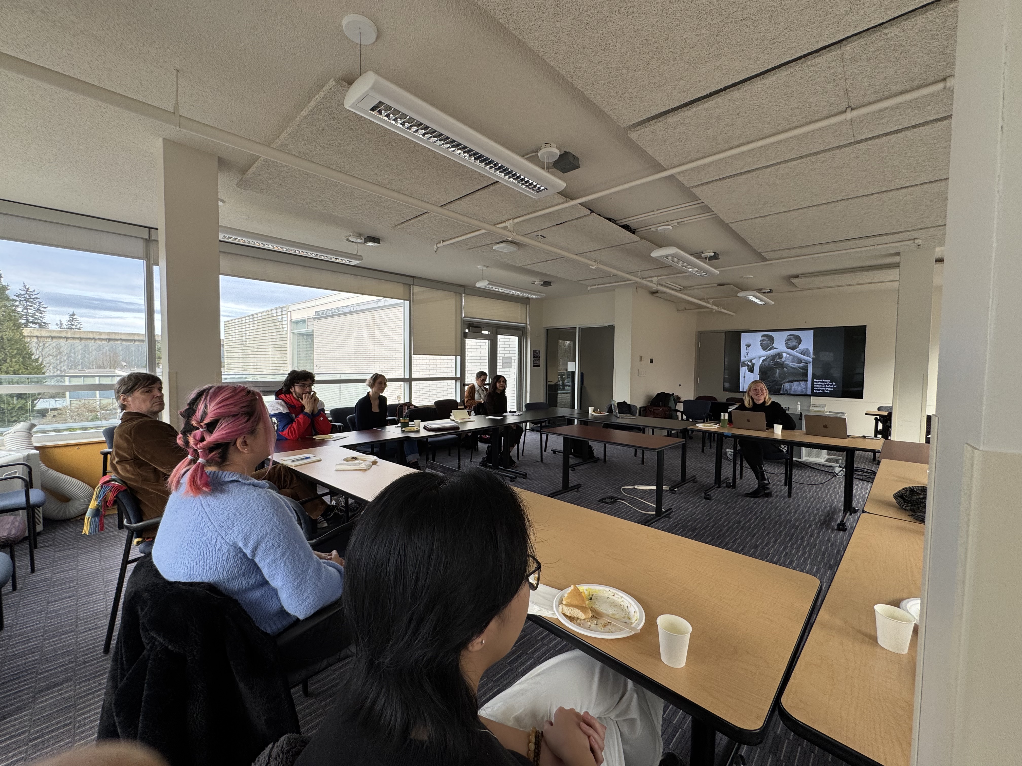 Attendees seated in the light filled Buchanan Penthouse at a roundtable facing Carolien Stolte. 