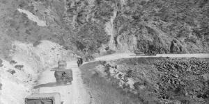 Trucks on winding dirt road: Korea, 1951