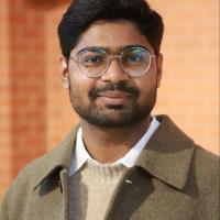 Krishna is looking at the camera.